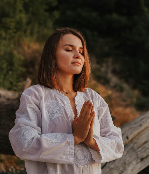 Person sitting in a serene meditation pose, surrounded by a peaceful atmosphere.
