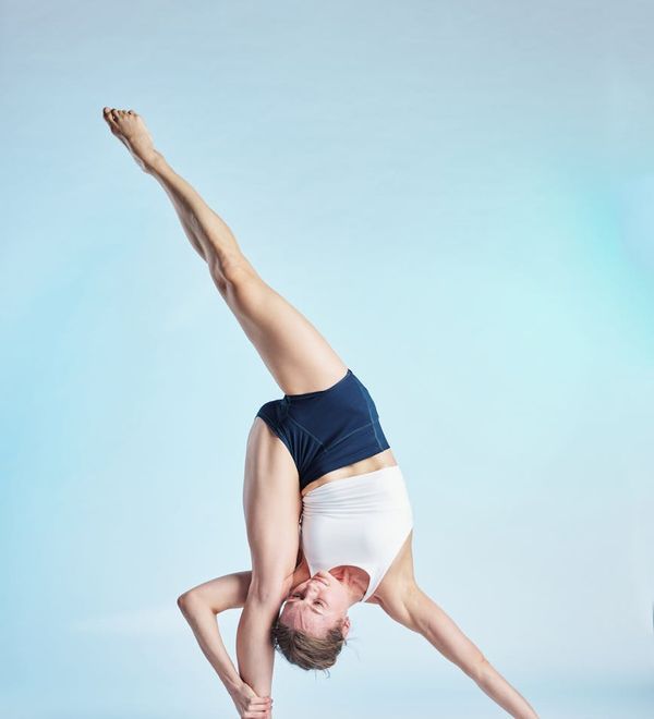 Woman in a calm yoga pose, embodying balance and flexibility.
